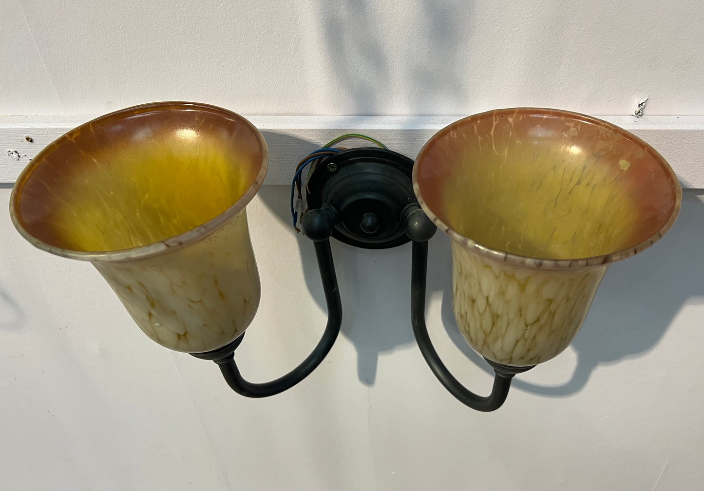 Antique brass double wall light with amber frosted shades