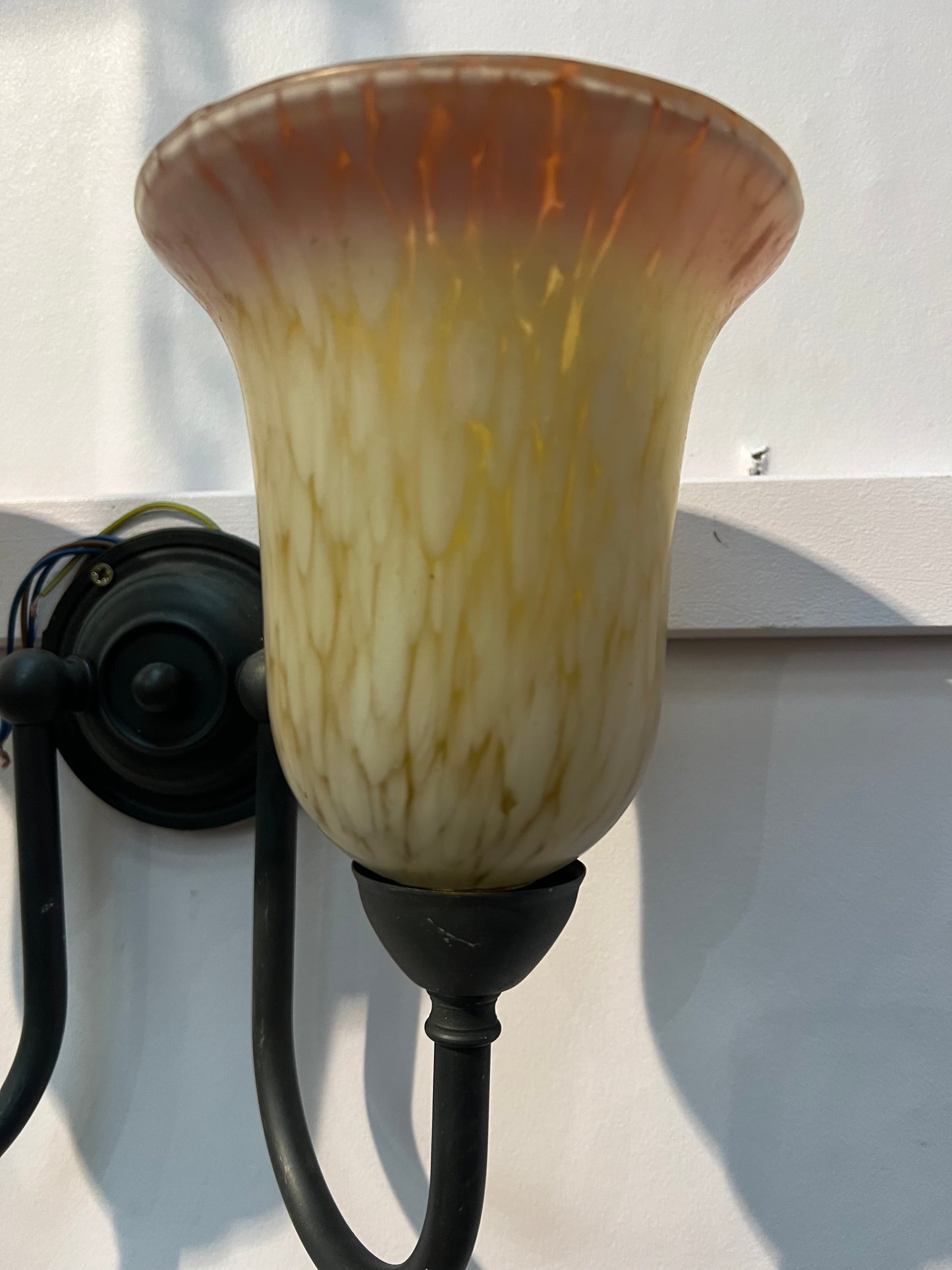Antique brass double wall light with amber frosted shades