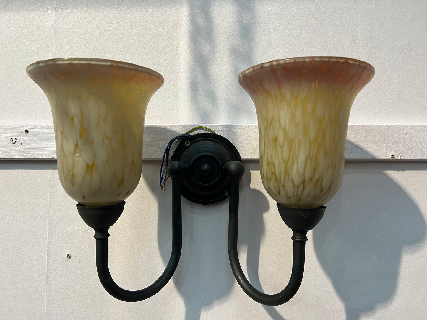 Antique brass double wall light with amber frosted shades