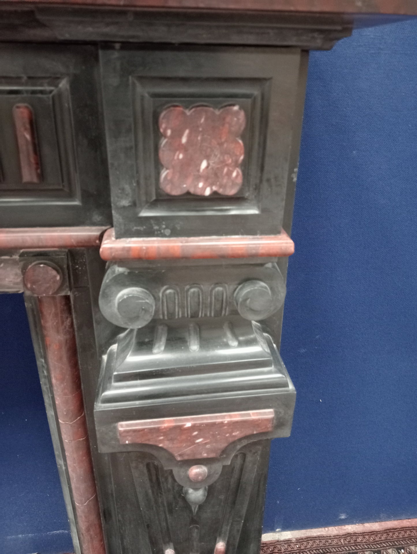 Black and maroon marble fireplace with corinthian tops