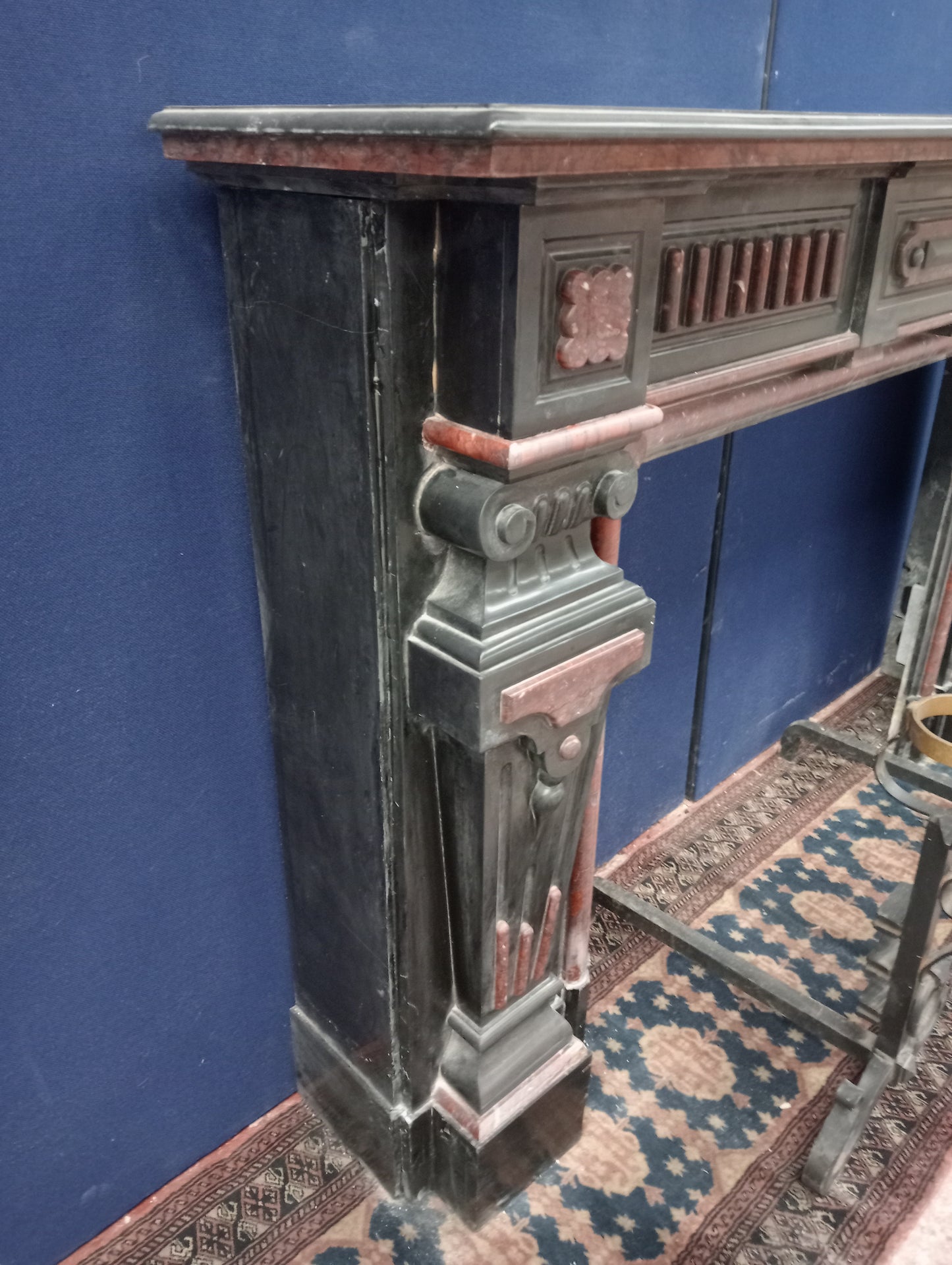Black and maroon marble fireplace with corinthian tops