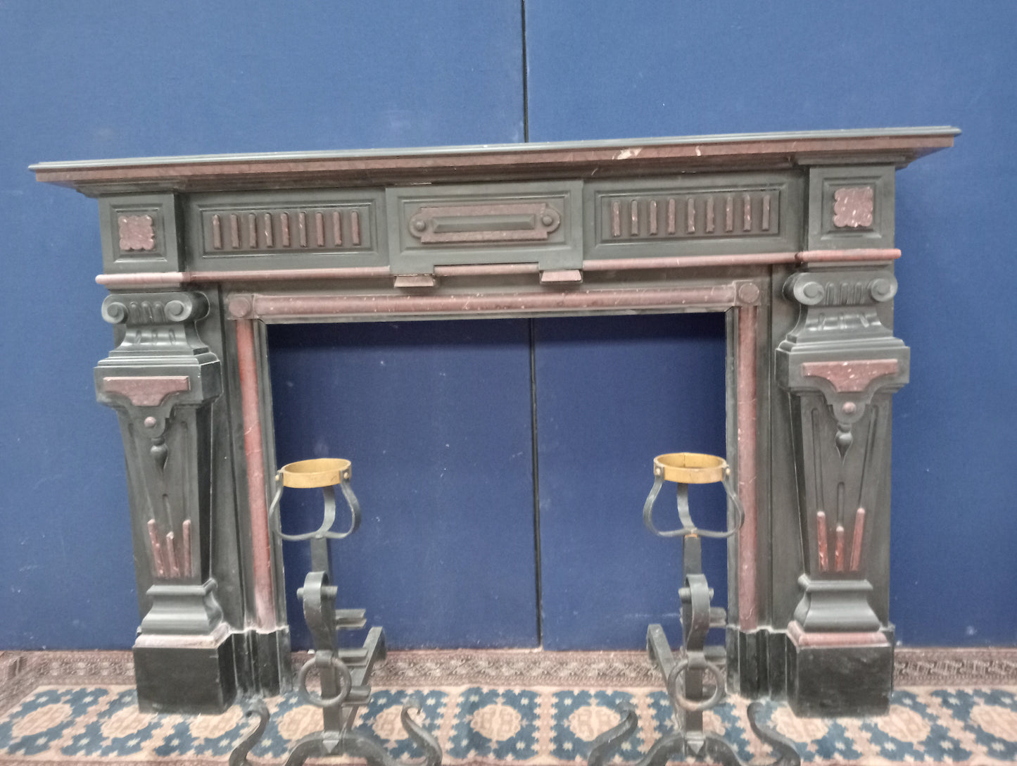 Black and maroon marble fireplace with corinthian tops