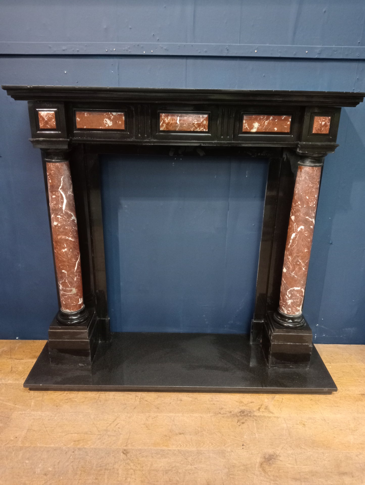Black marble fireplace with red and white marble columns