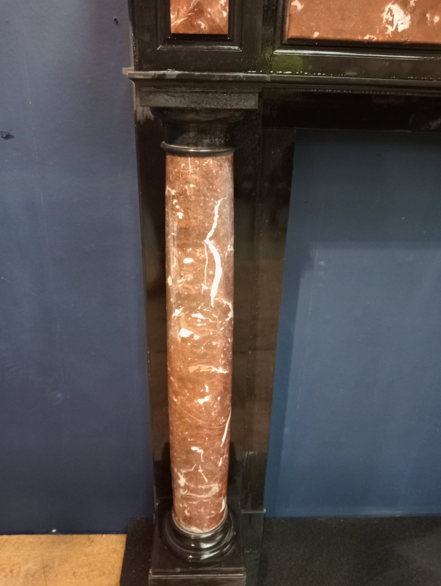 Black marble fireplace with red and white marble columns