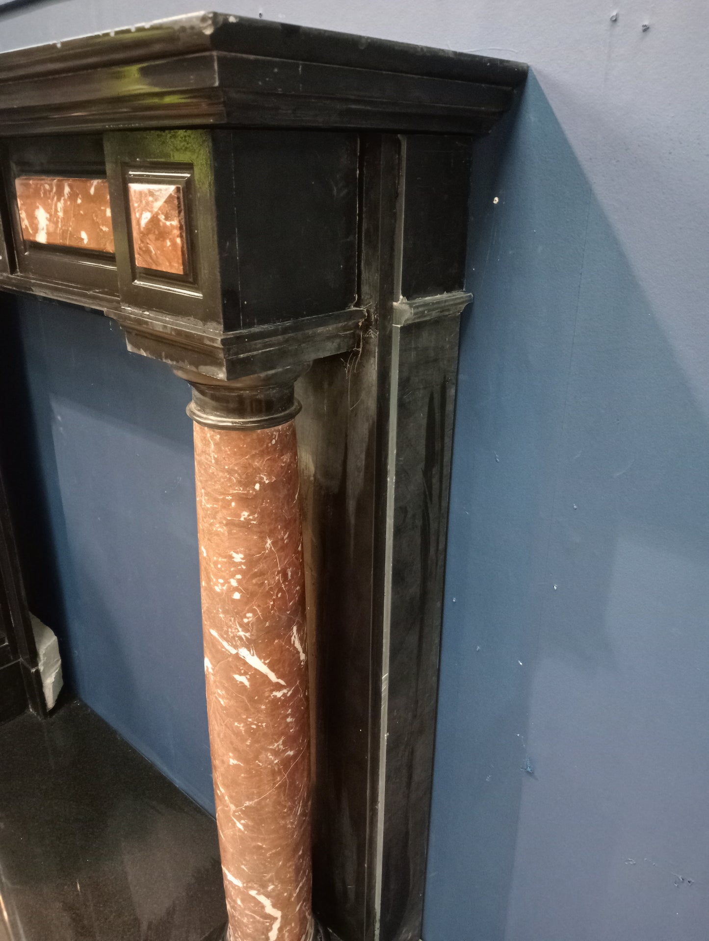 Black marble fireplace with red and white marble columns