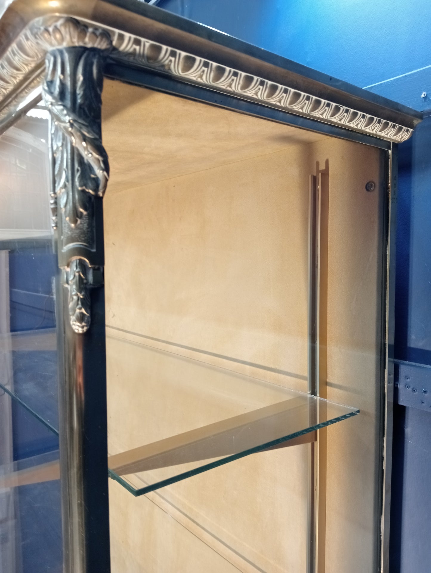 Brass glazed shop cabinet display with single drawer on brass feet with lights