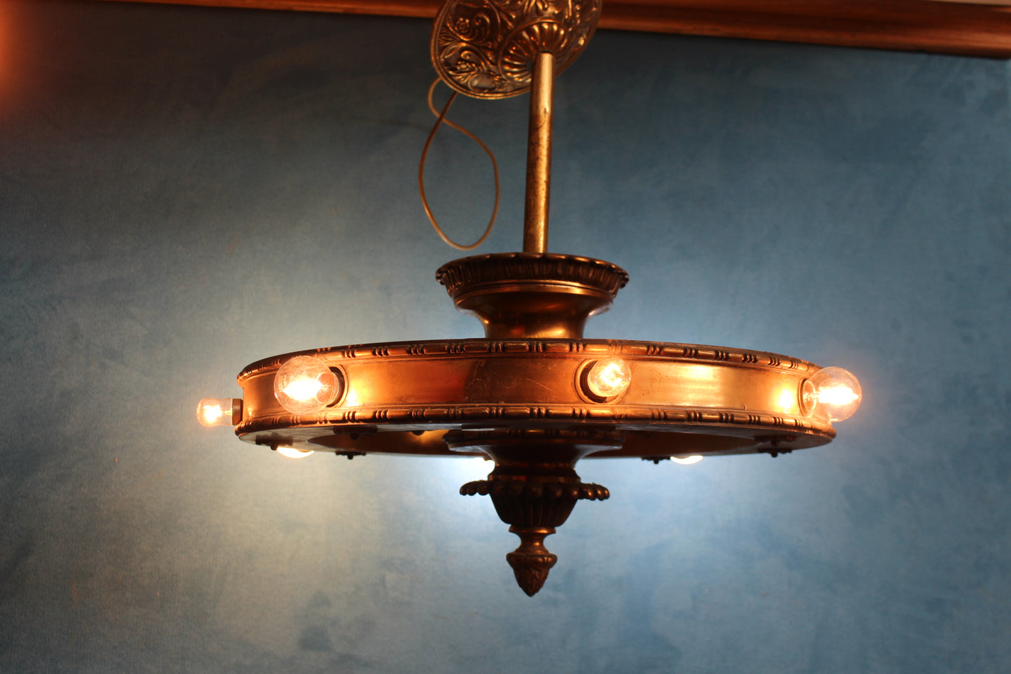 Brass hanging ceiling light in the form of a wagon wheel