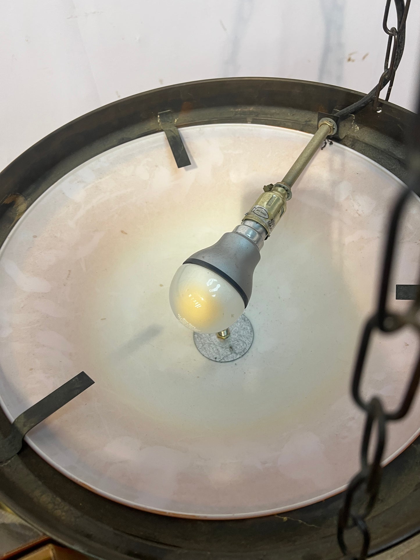 Brass rim hanging uplighter with amber shade