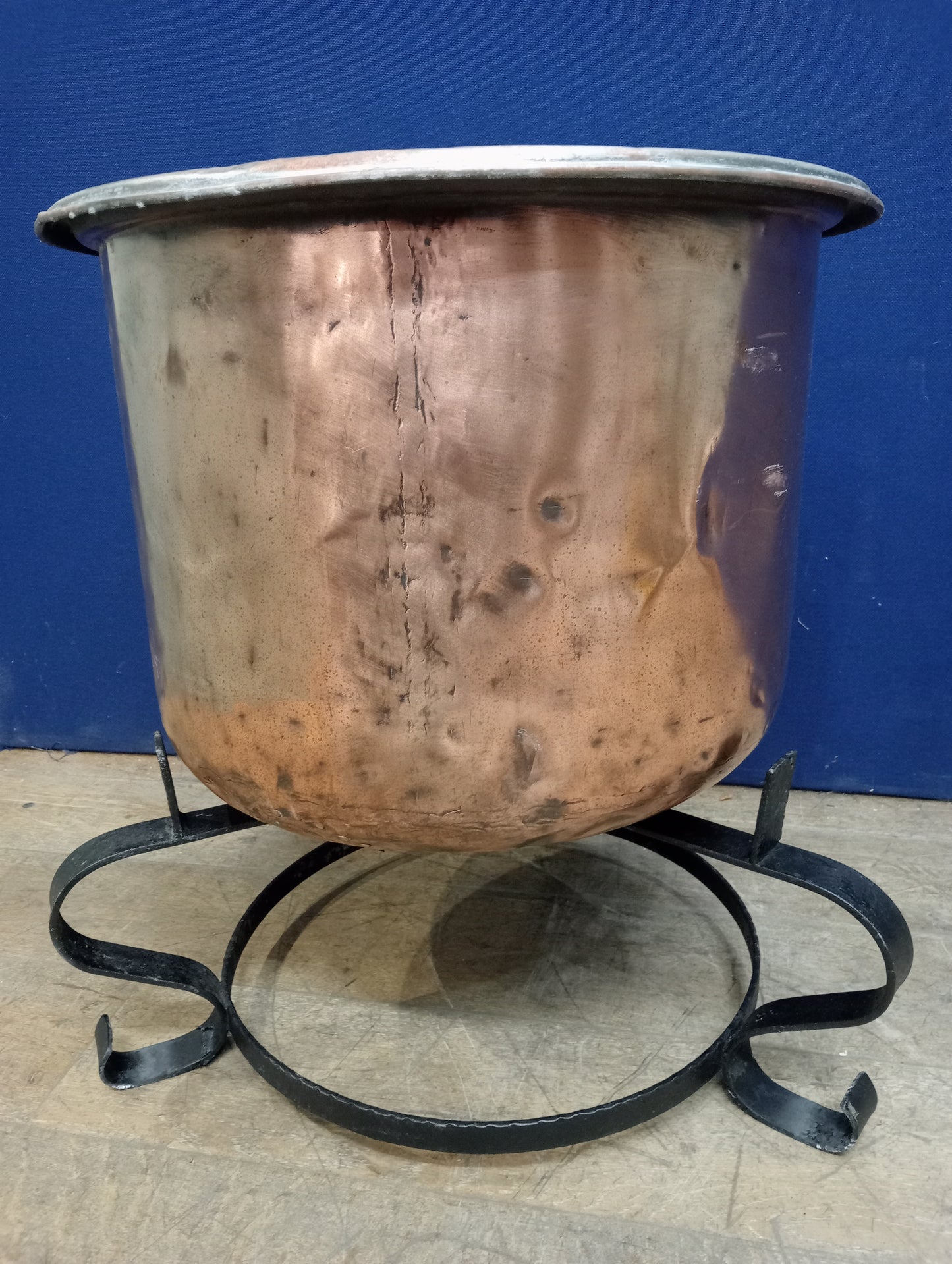 Large copper pot on wrought iron base scroll legs