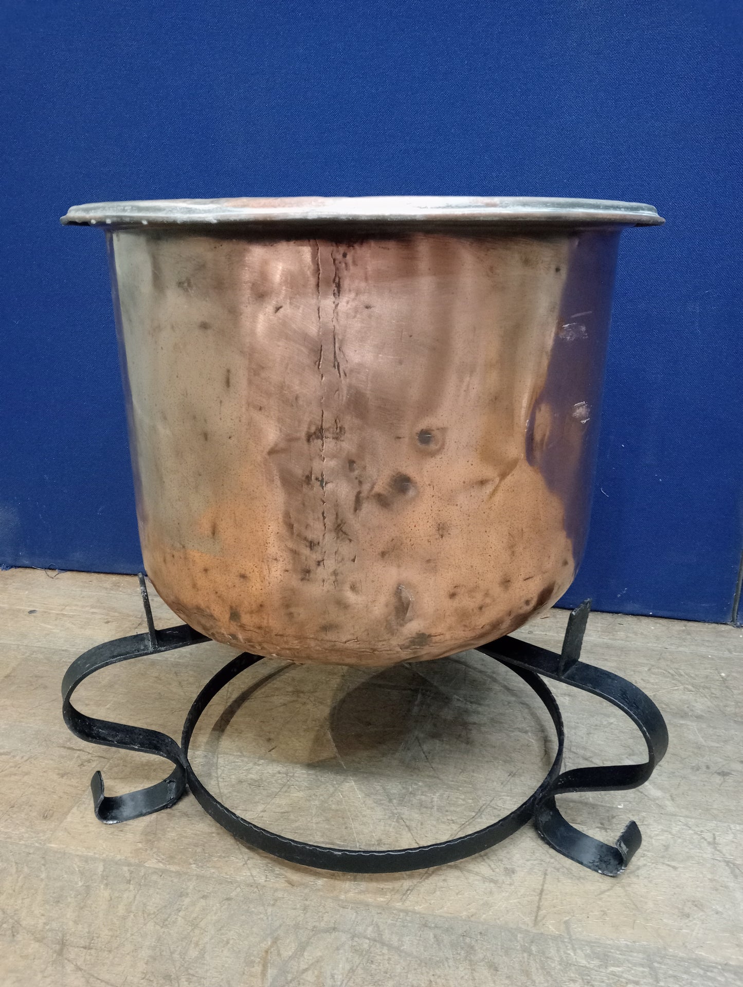 Large copper pot on wrought iron base scroll legs