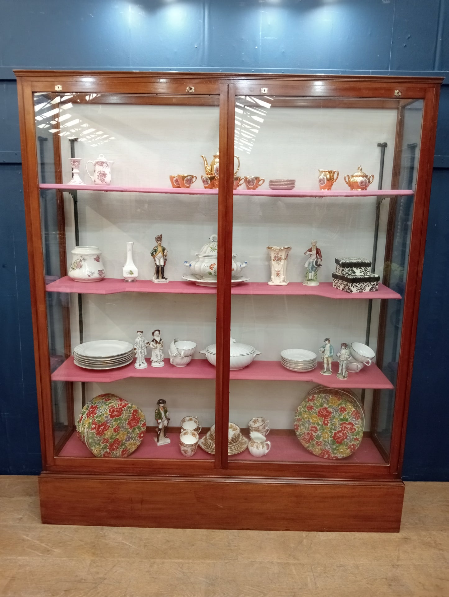 Mahogany glazed shop cabinet pink velvet upholstered shelves