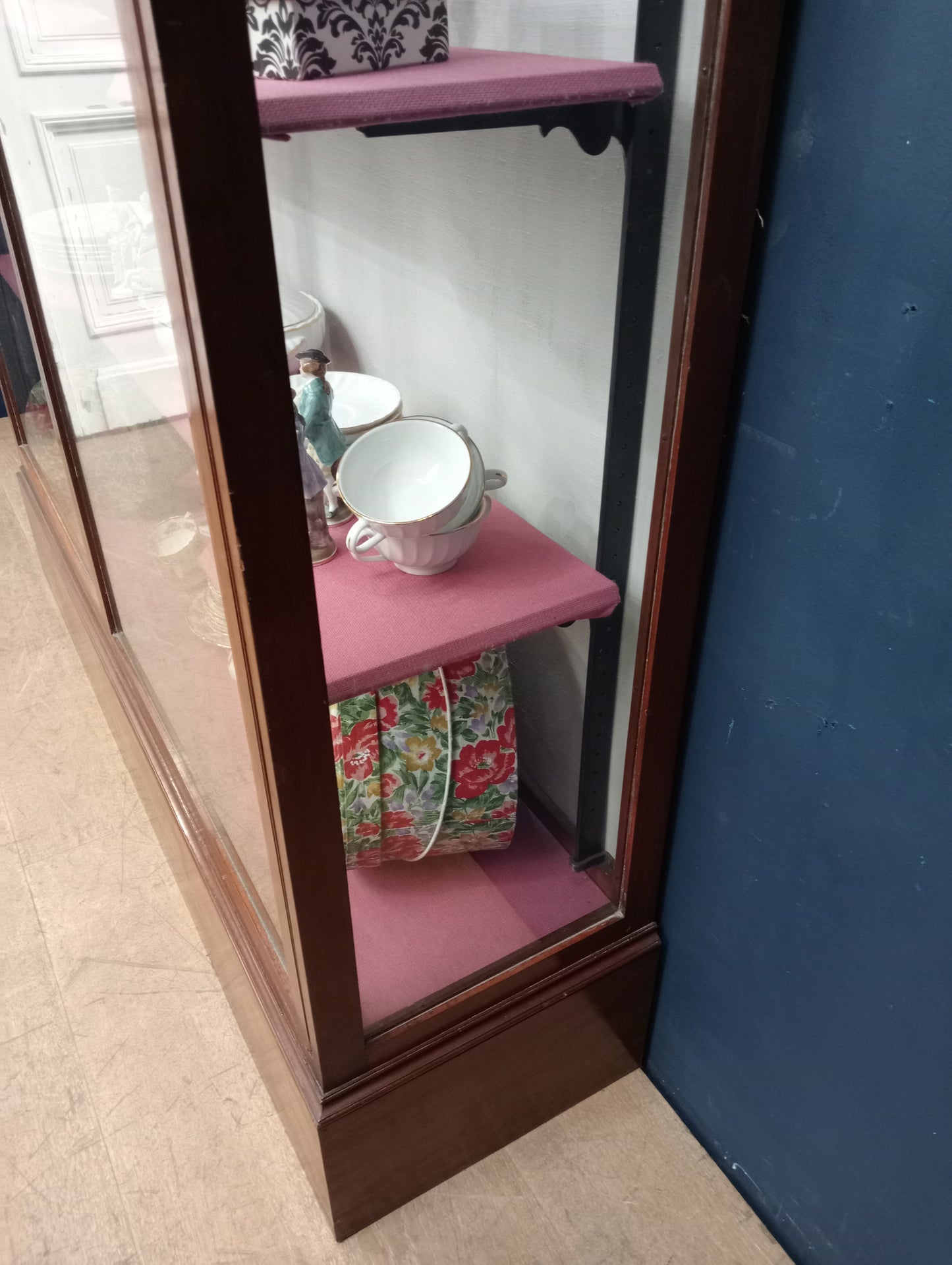 Mahogany glazed shop cabinet pink velvet upholstered shelves