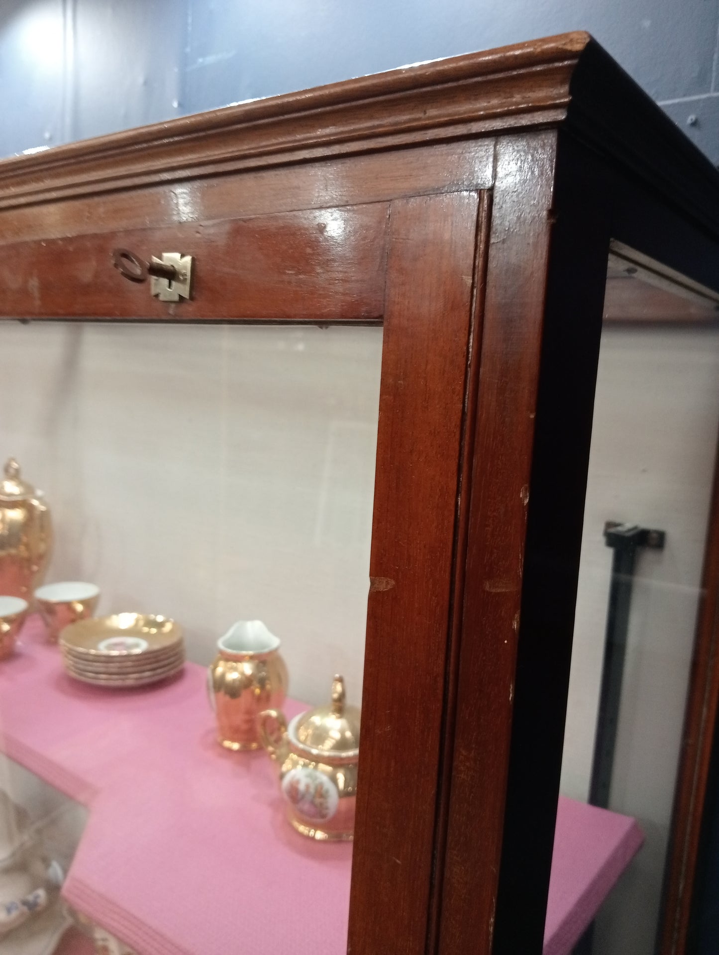 Mahogany glazed shop cabinet pink velvet upholstered shelves
