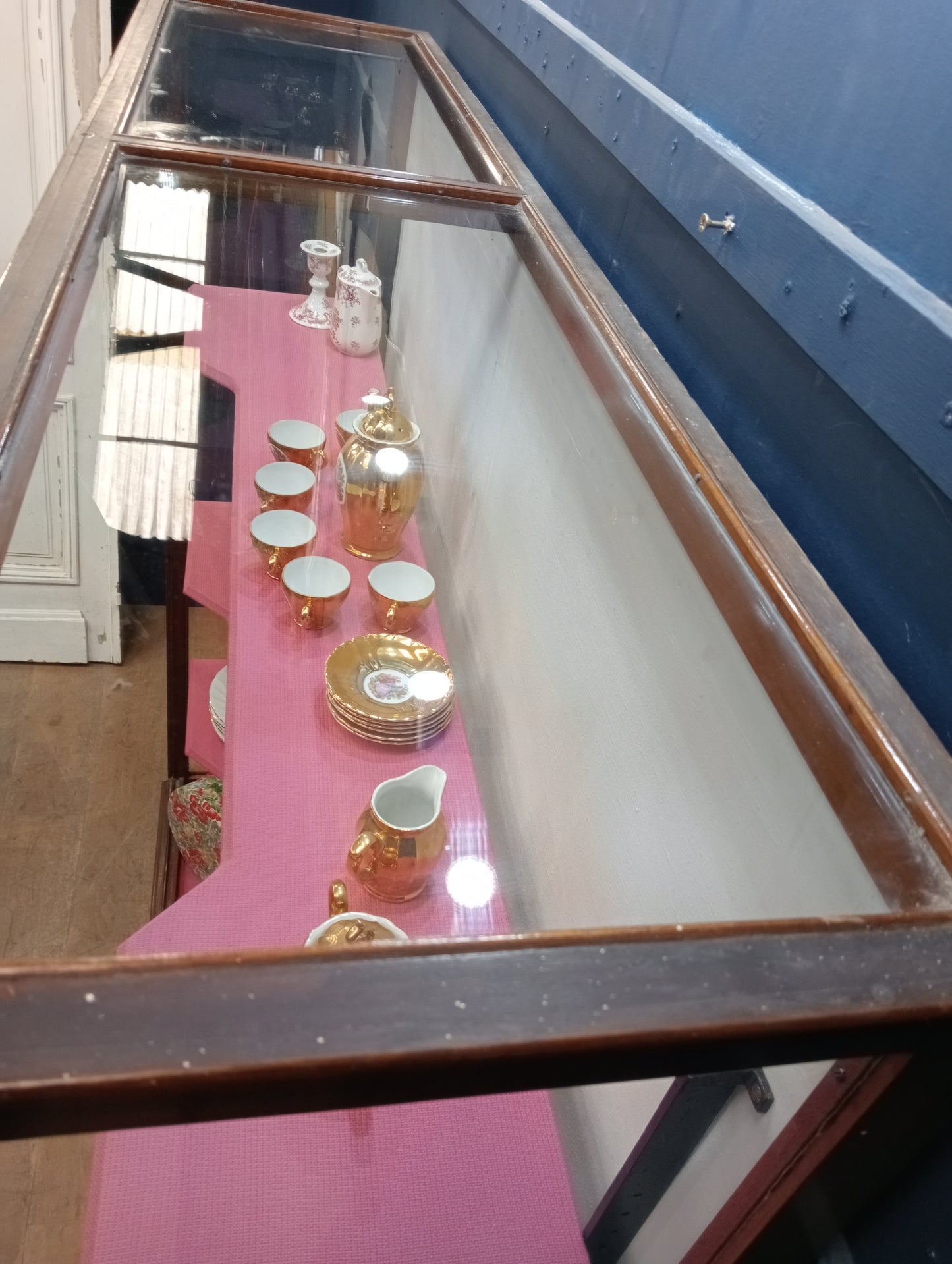 Mahogany glazed shop cabinet pink velvet upholstered shelves