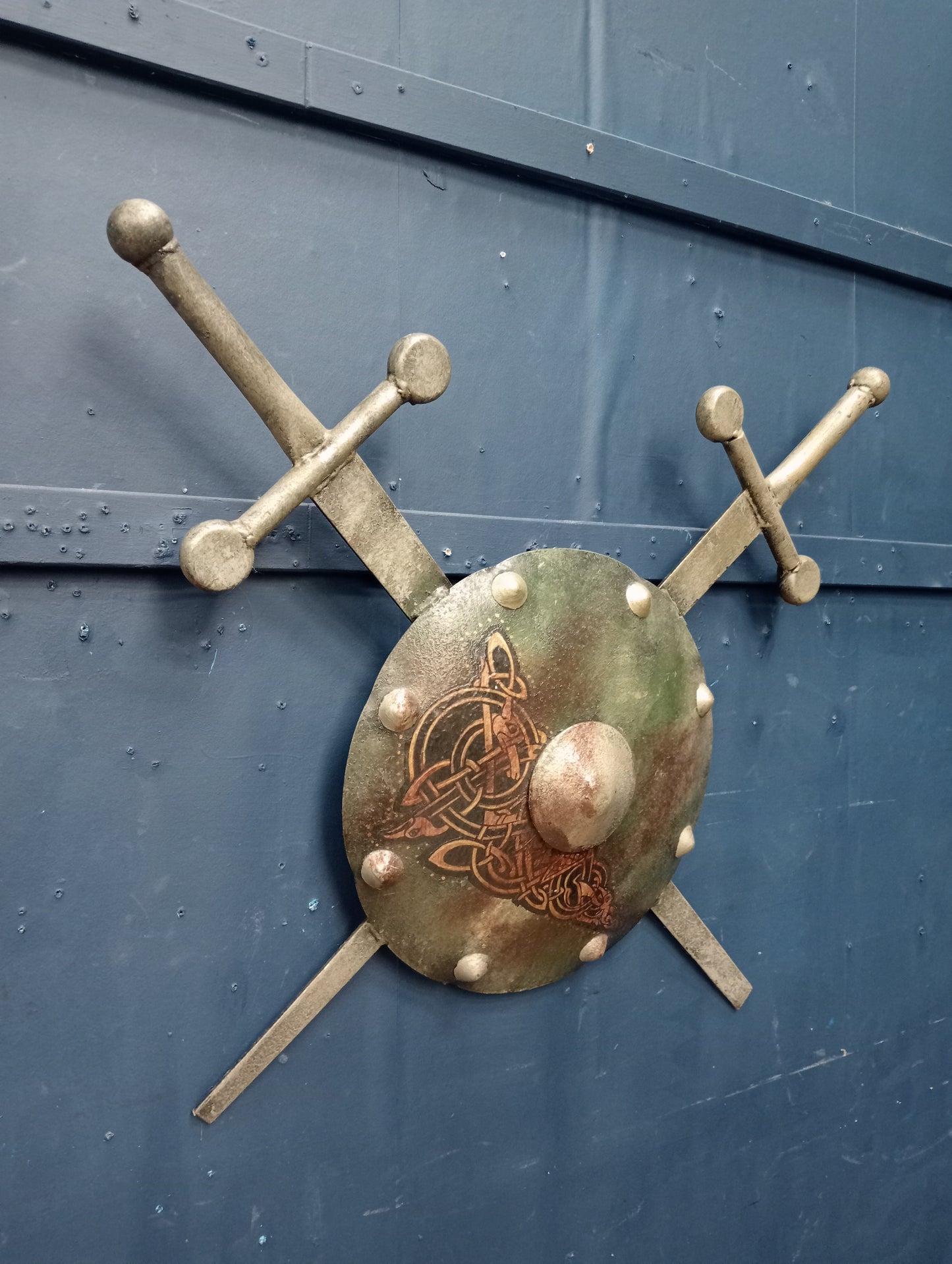 Metal shield with swords