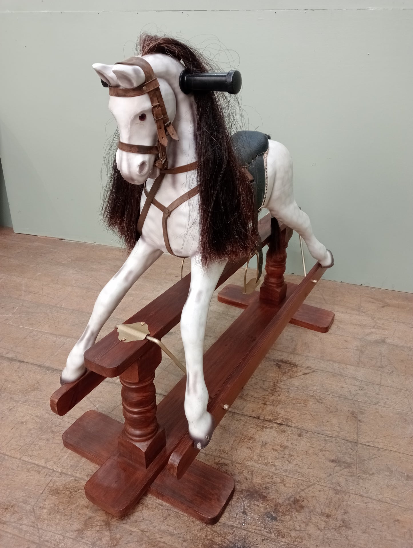Painted dapple grey rocking horse with leather reins and saddle