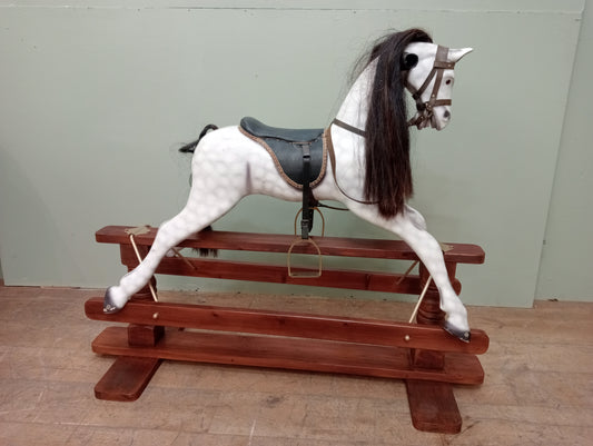 Painted dapple grey rocking horse with leather reins and saddle