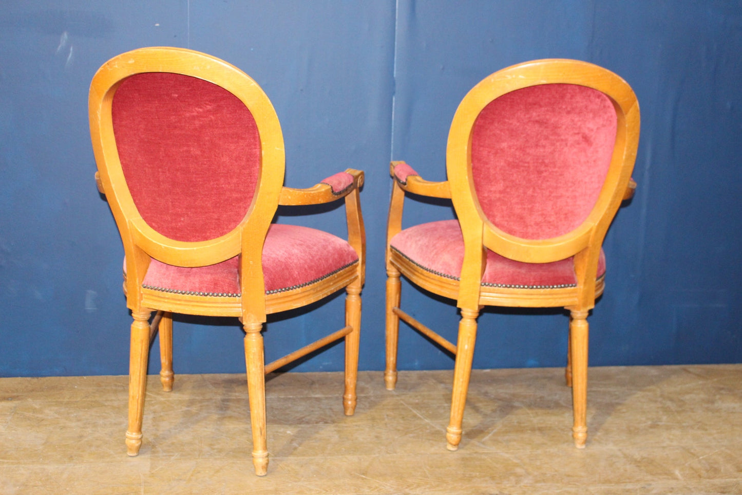 Pair of red draylon round back Louie carvers