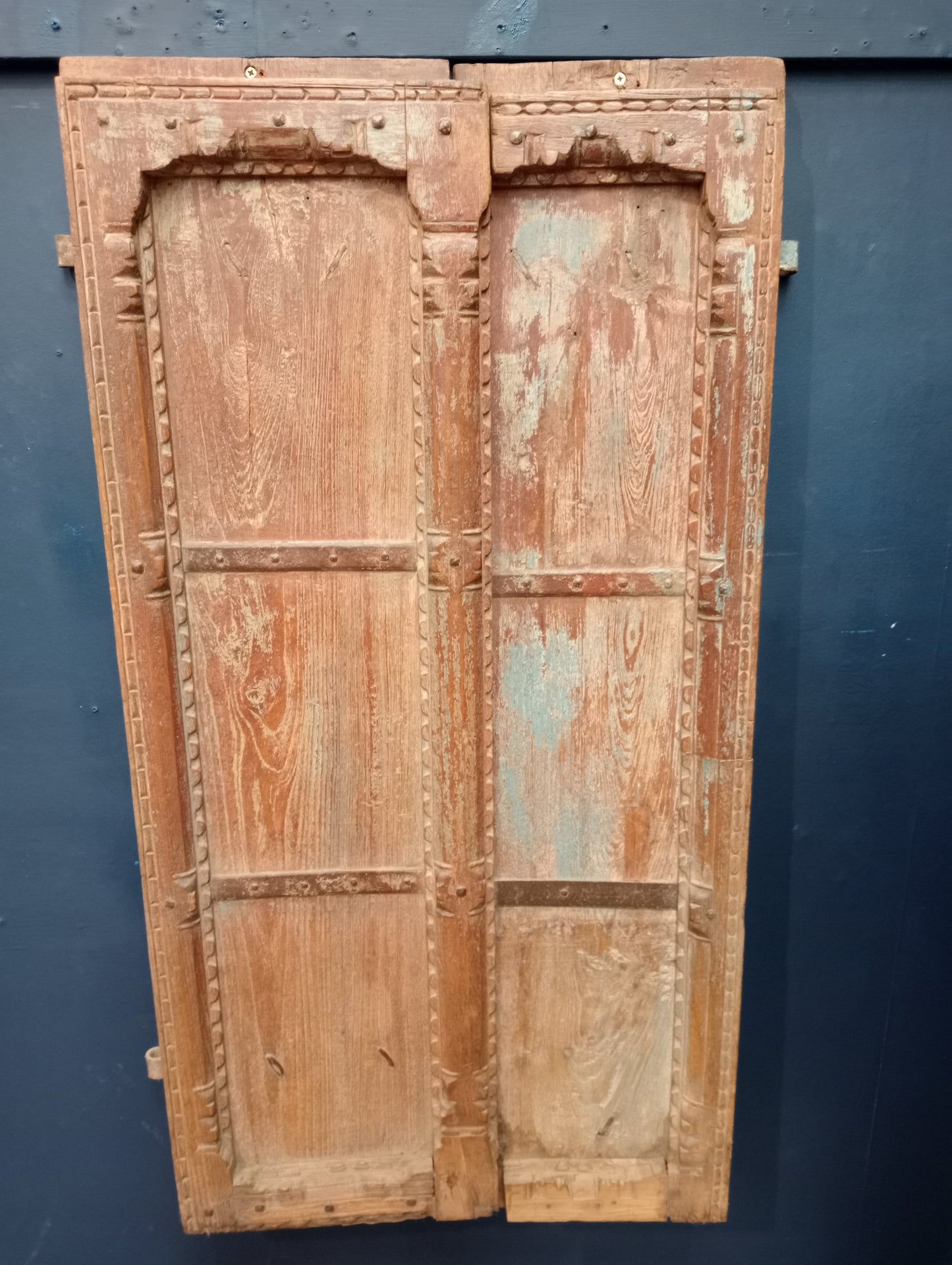 Carved wooden Moroccan door with metal panels and studding