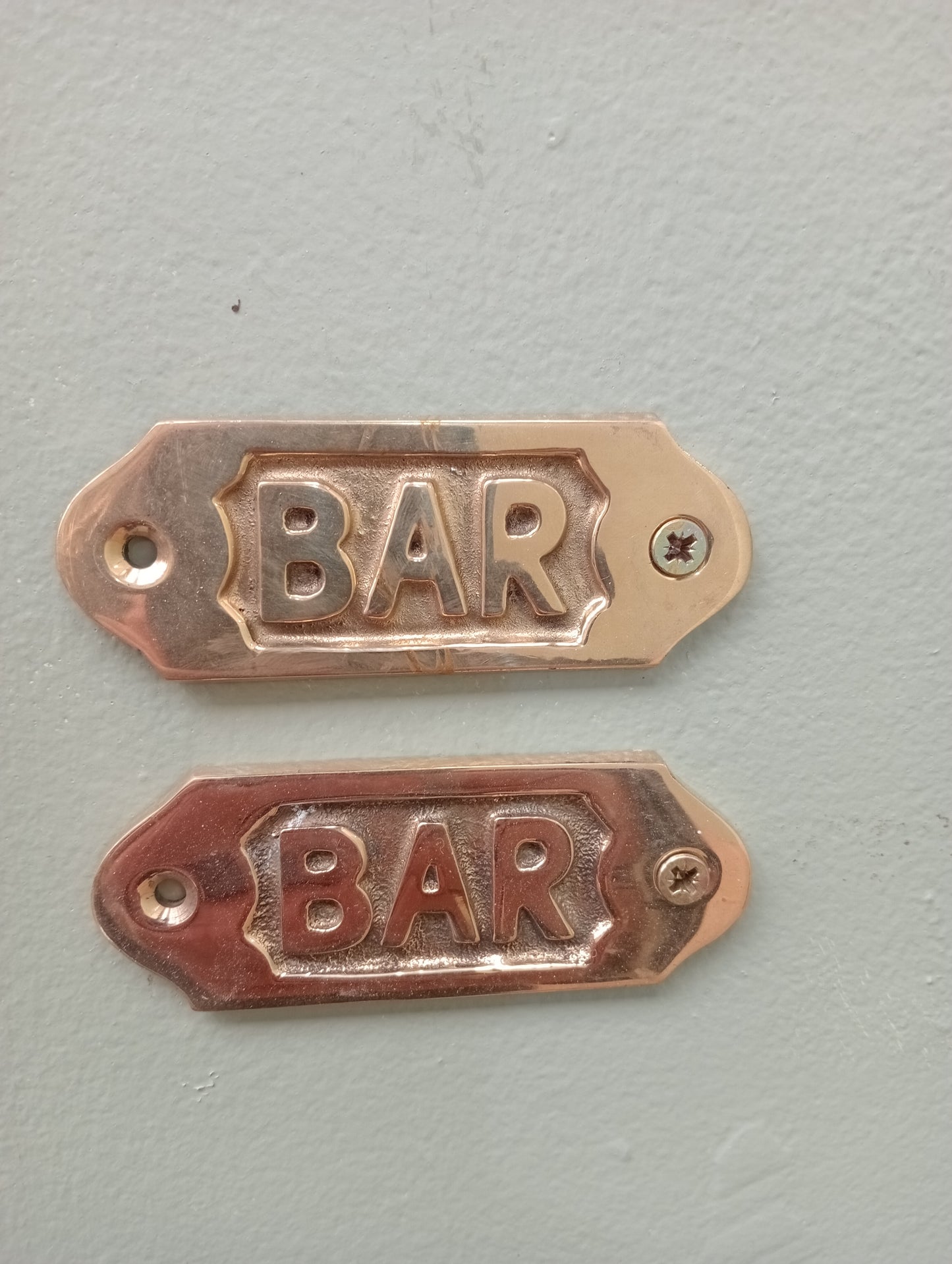 Pair of brass bar signs