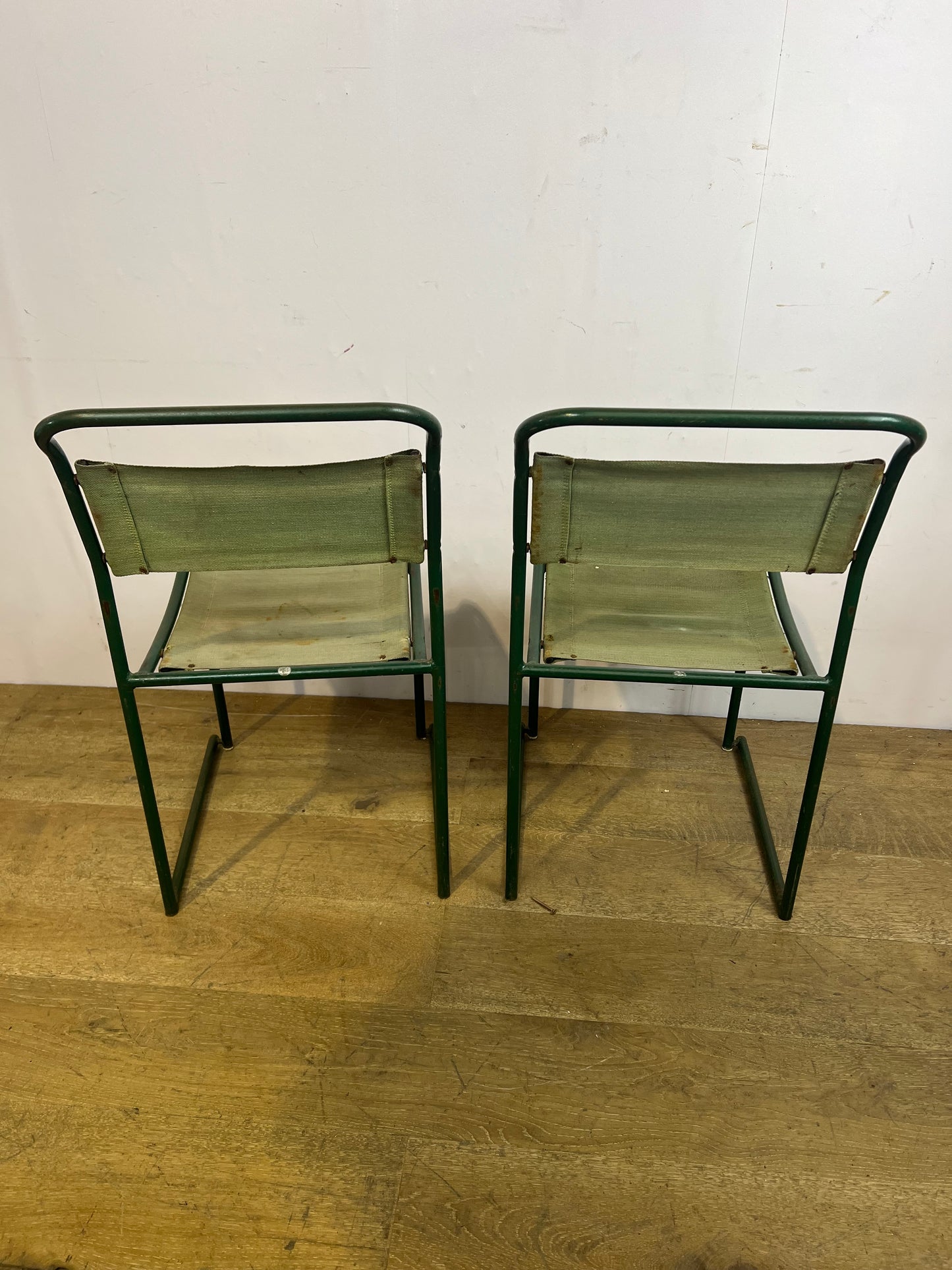 Pair of green metal stacking chairs