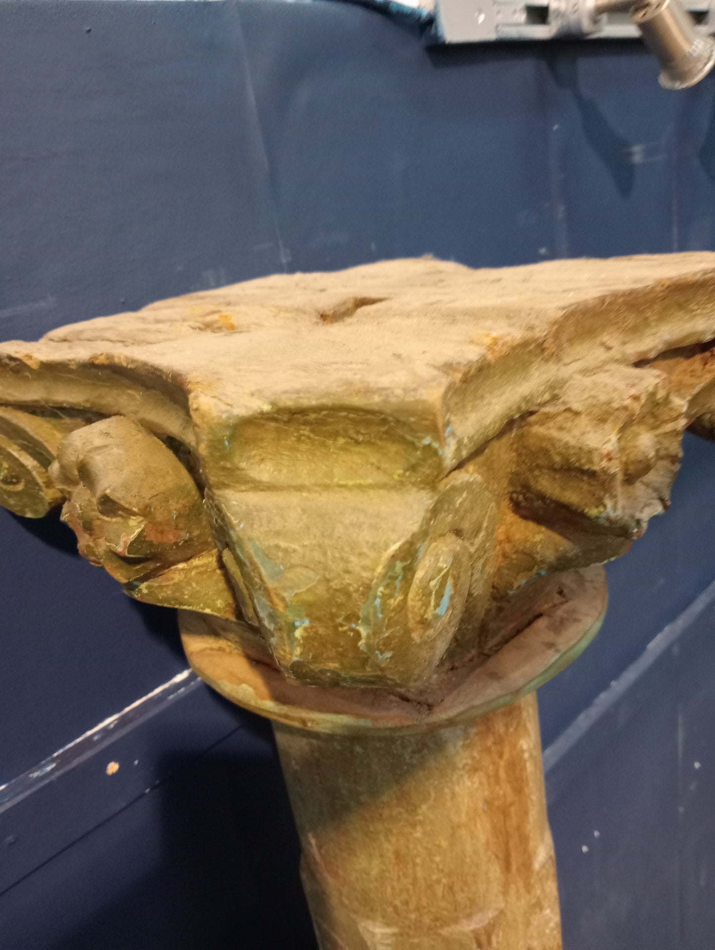 Pair of wooden pillars with corinthian wood top on sandstone base