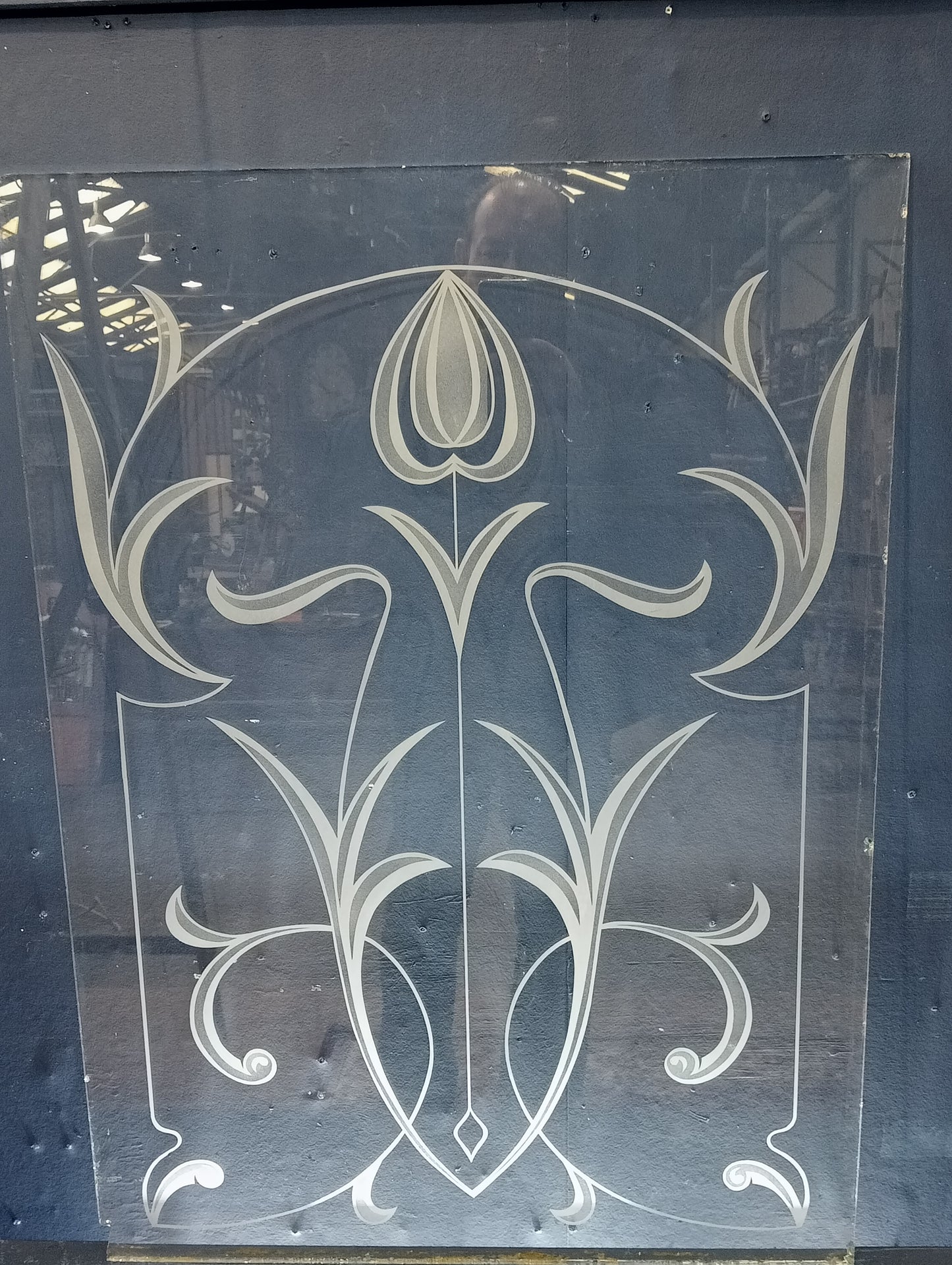 Pane of glass with frosted flower