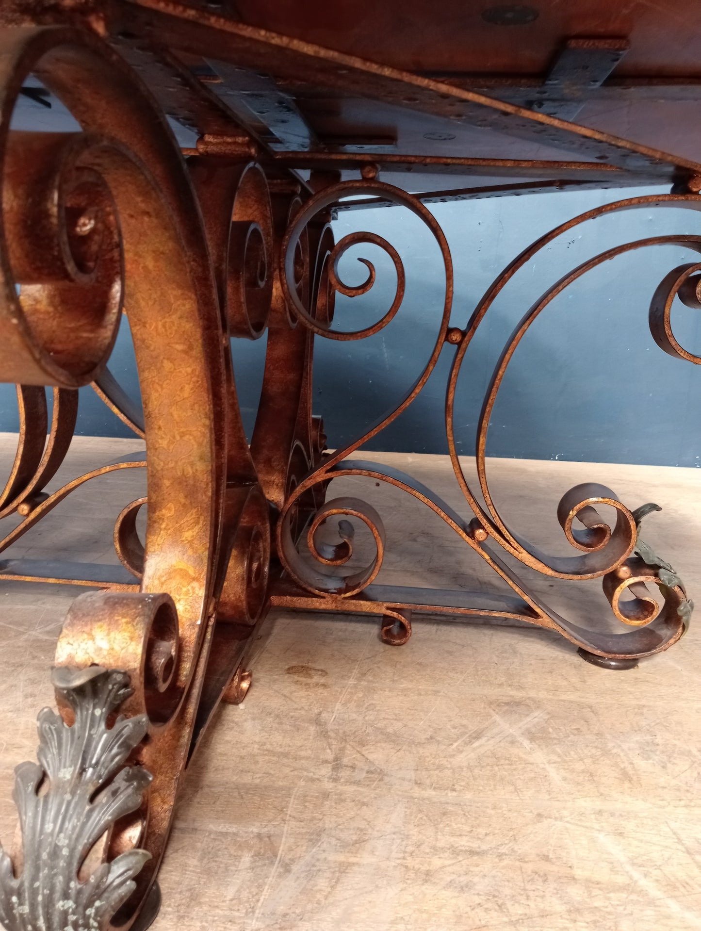 Walnut veneered table with scrolled wrought iron base anthius leaf design
