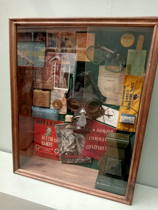Wartime glazed showcase , gasmask light , field dressings. Books , old photos