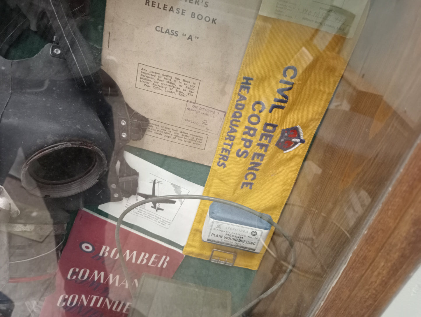 Wartime glazed showcase , gasmask light , field dressisngs. Books , old photos