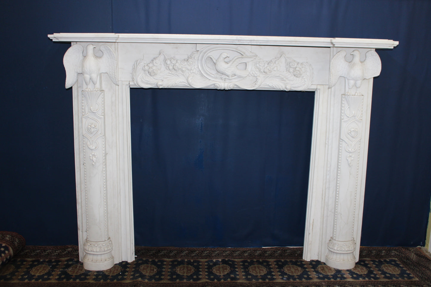 White marble fireplace with handcarved eagles