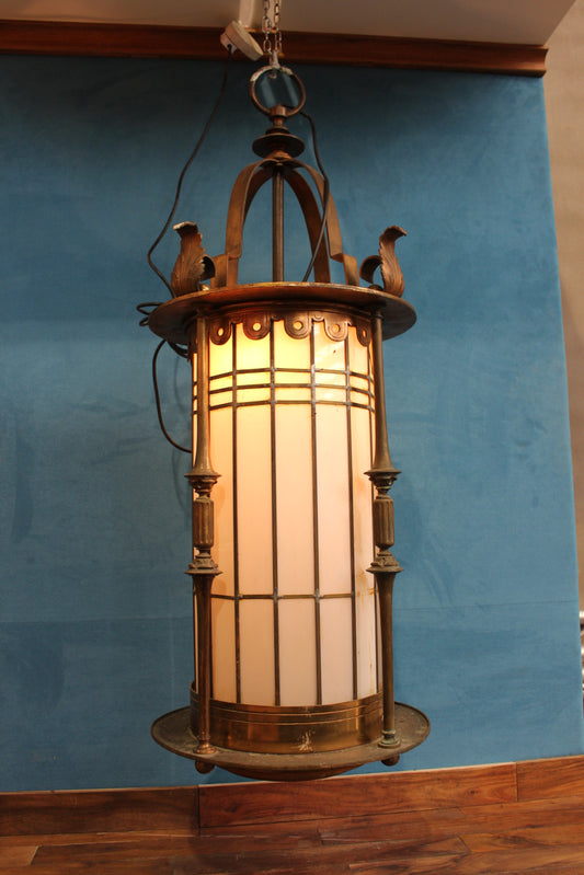 Brass hanging light decorated with acanthus leaves and opaque glass panels