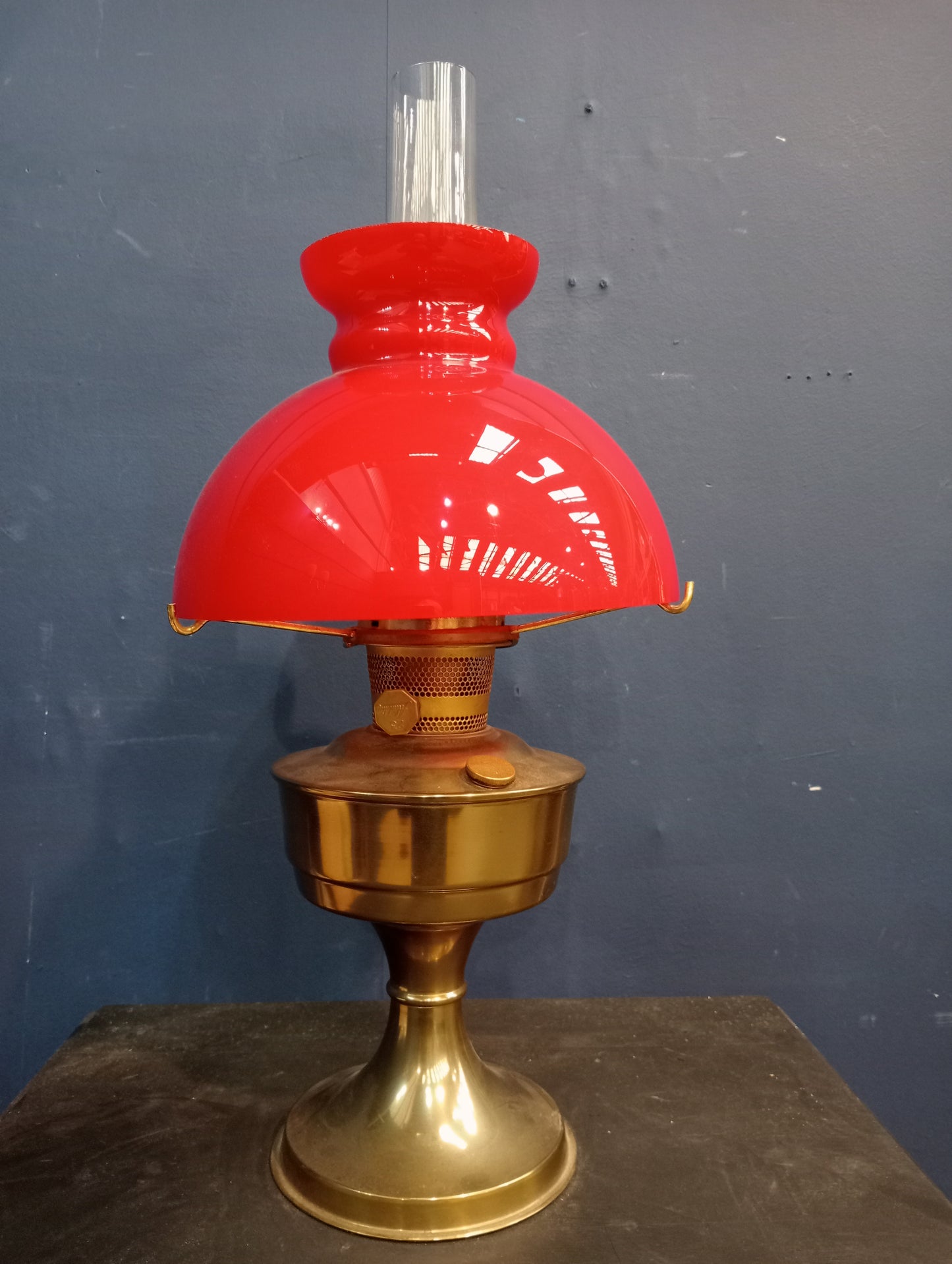 Brass oil lamp with red glass shade