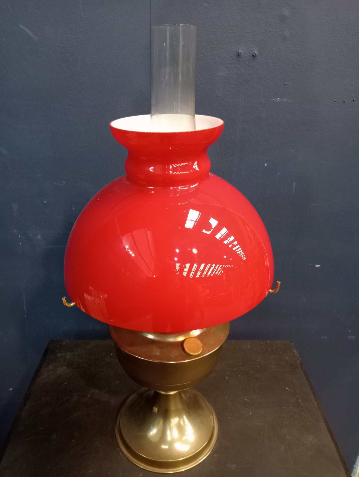 Brass oil lamp with red glass shade