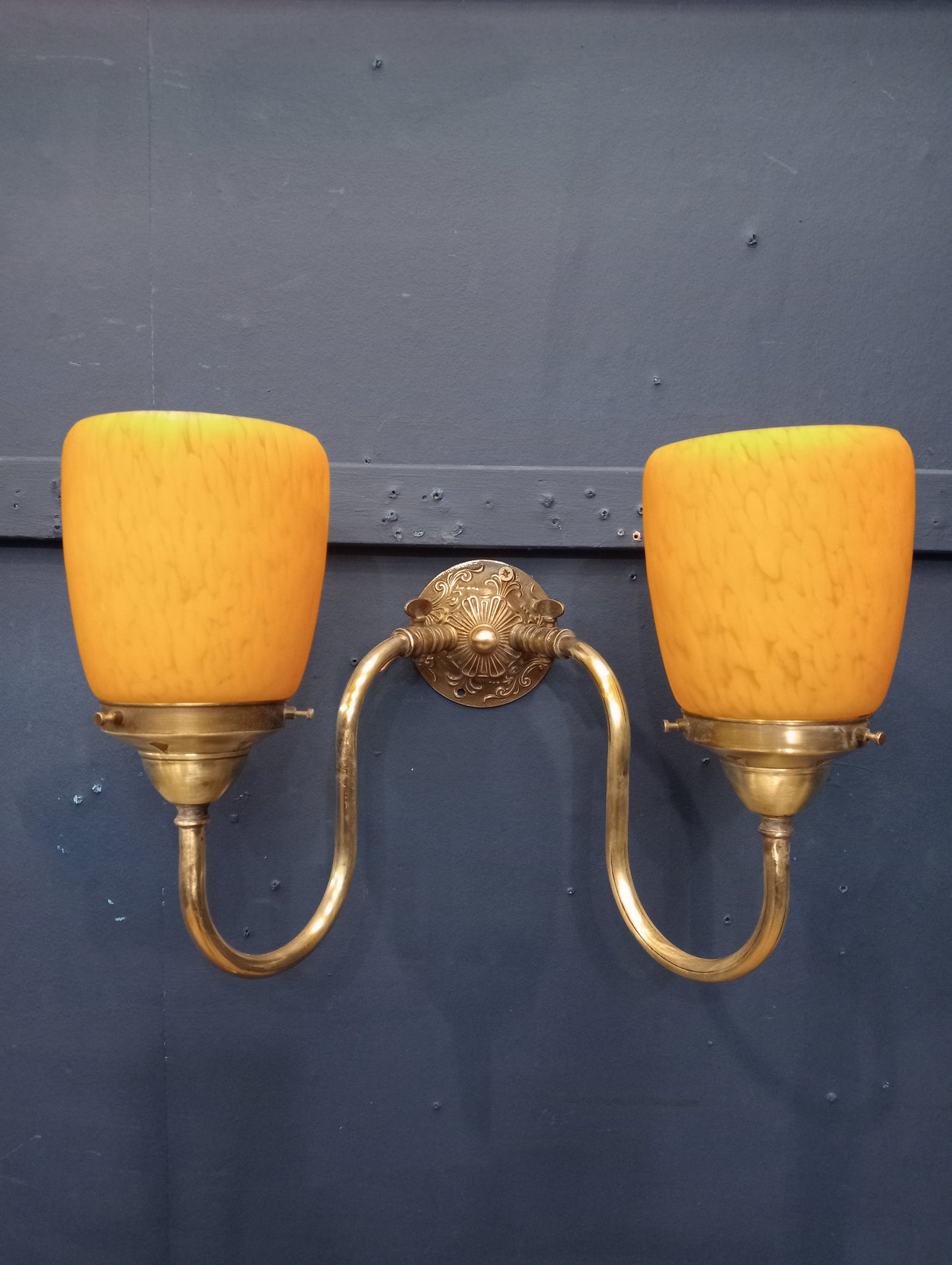 Brass wall light with amber shades