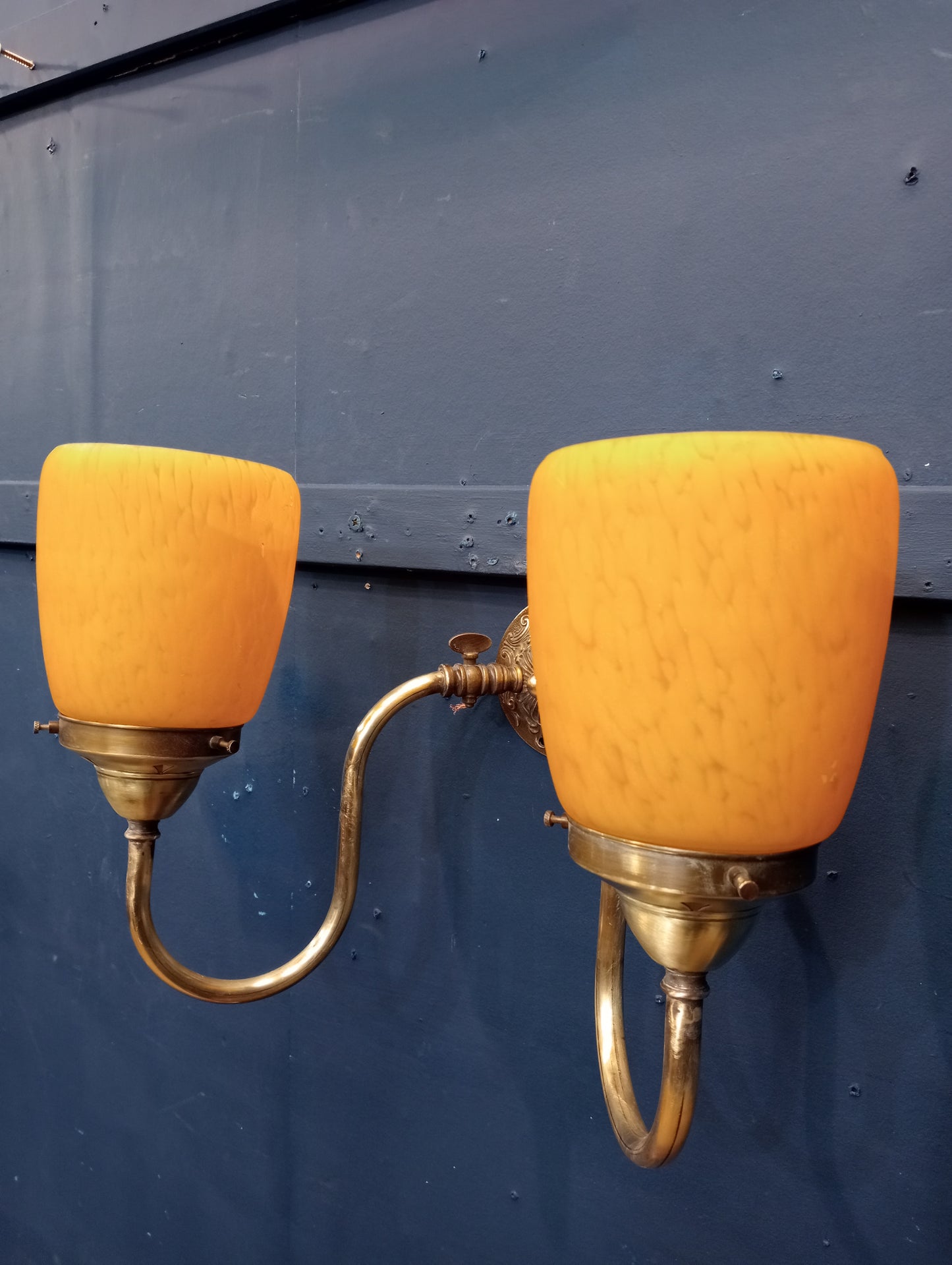 Brass wall light with amber shades