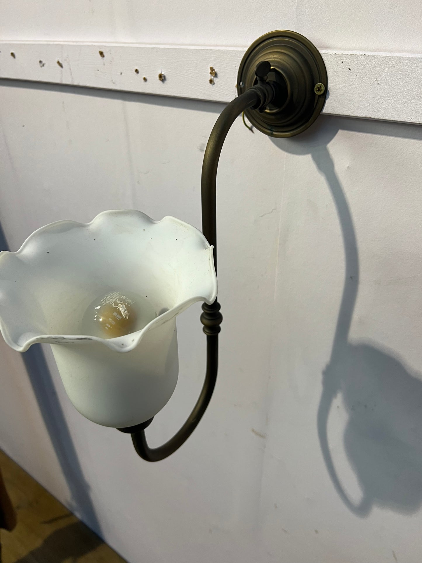 Brass wall light with white tulip shade