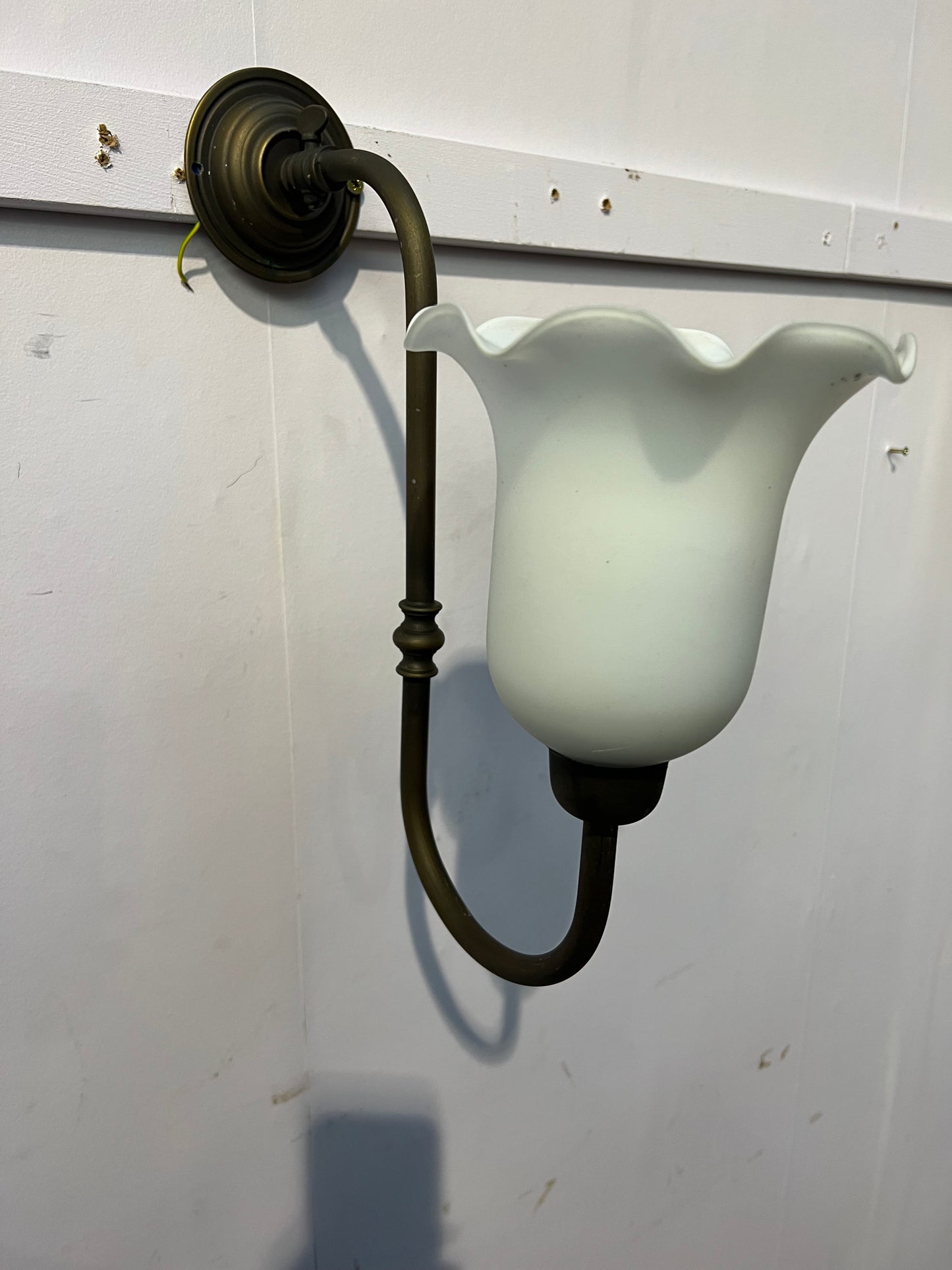 Brass wall light with white tulip shade