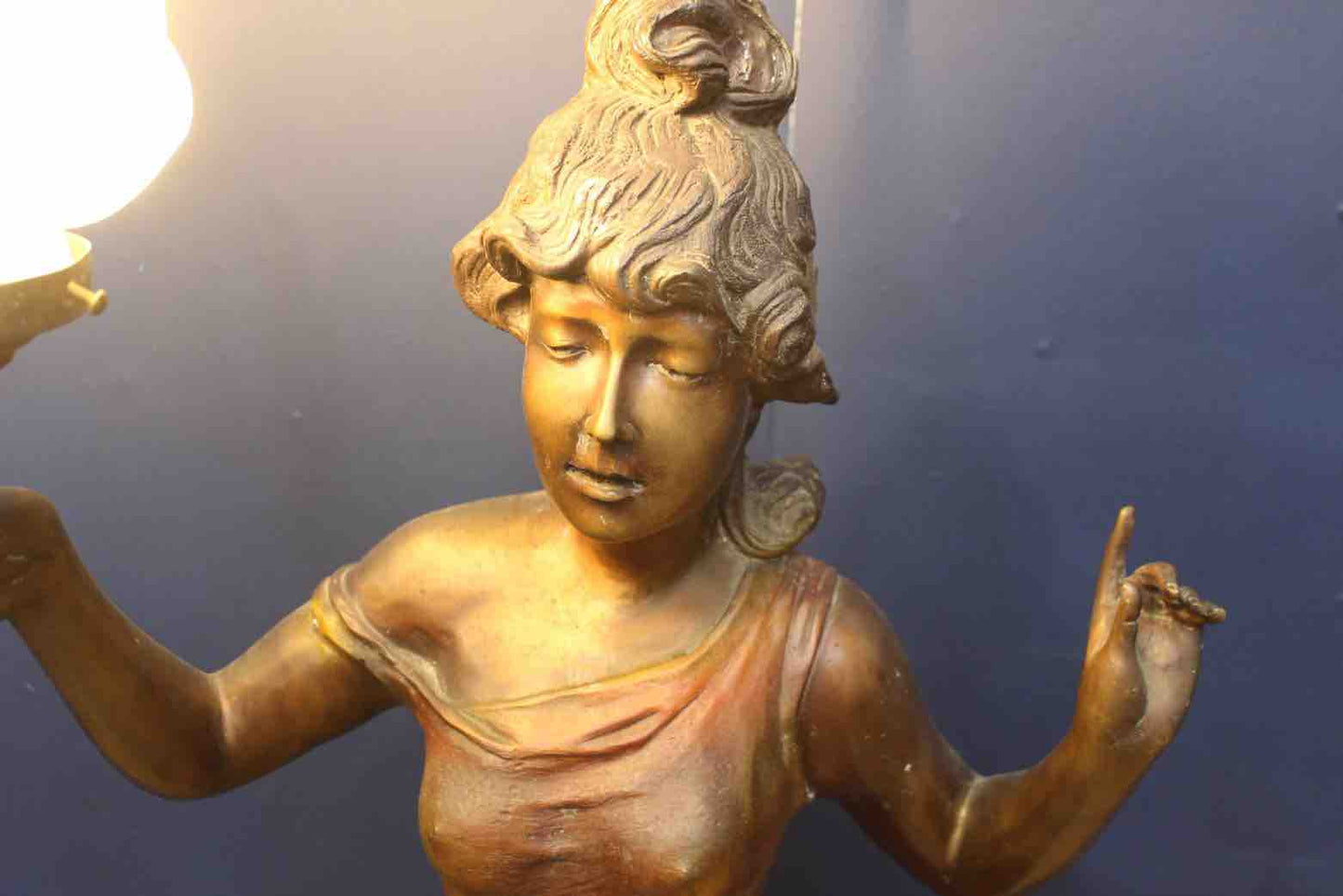 Bronze lady holding light with flame shade