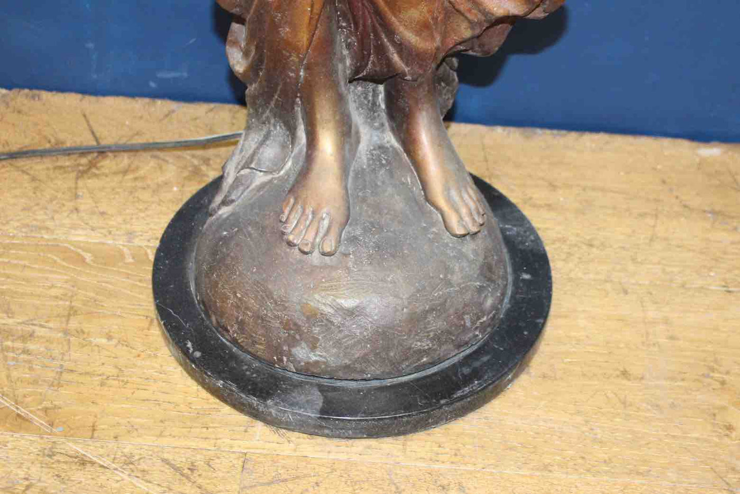 Bronze lady holding light with flame shade