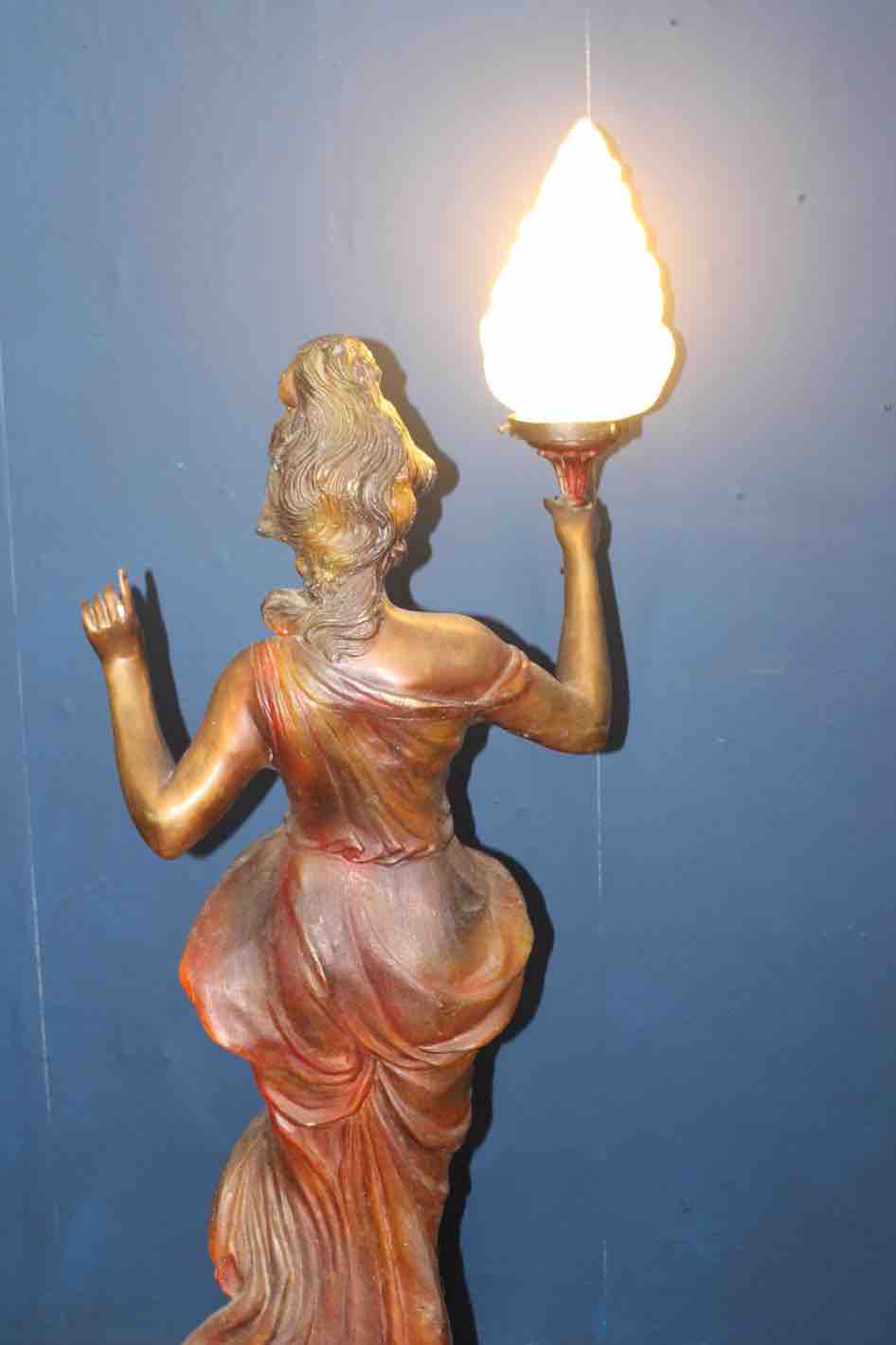 Bronze lady holding light with flame shade