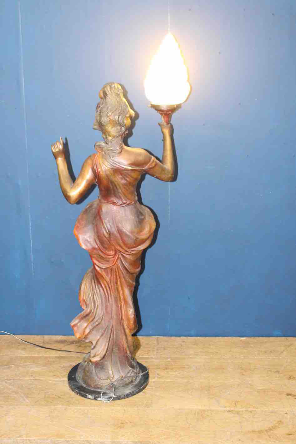 Bronze lady holding light with flame shade