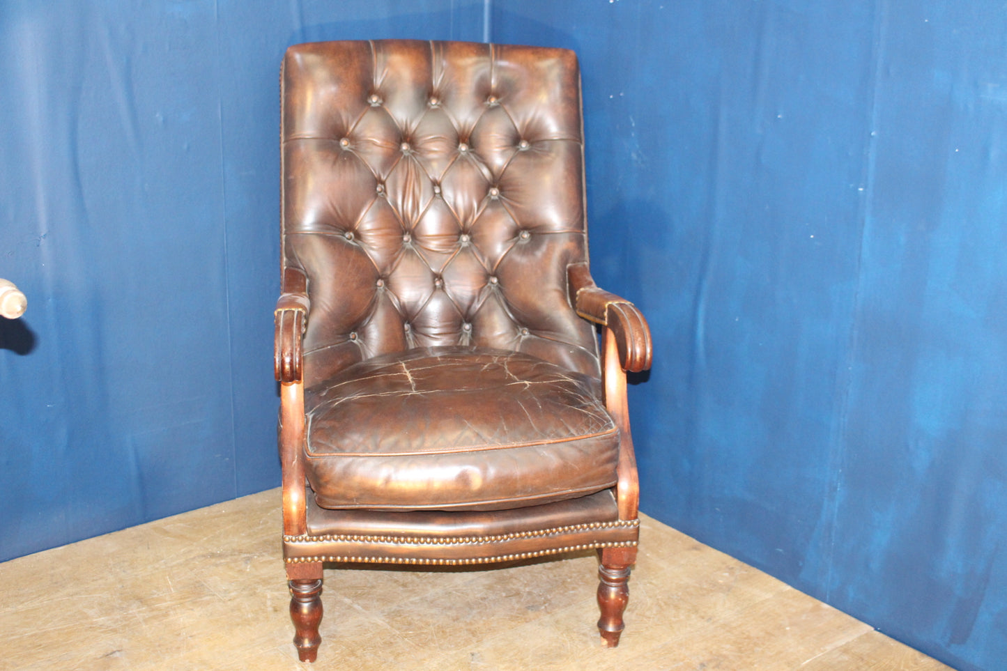 Brown leather deep buttoned armchair