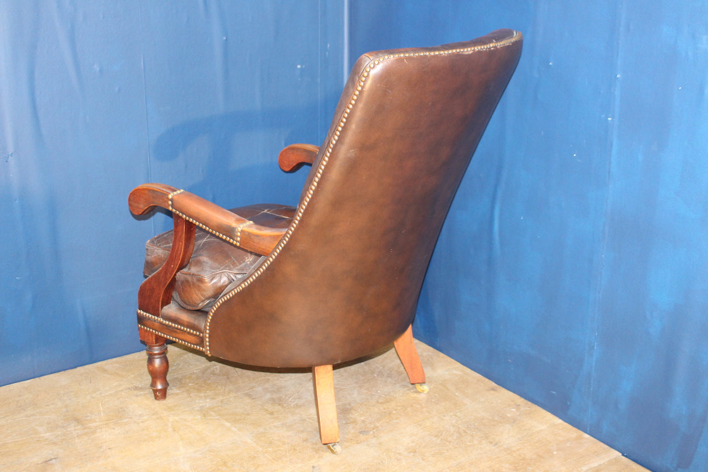 Brown leather deep buttoned armchair