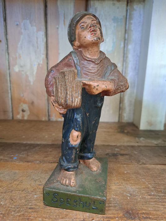 Cast iron newspaper boy figure