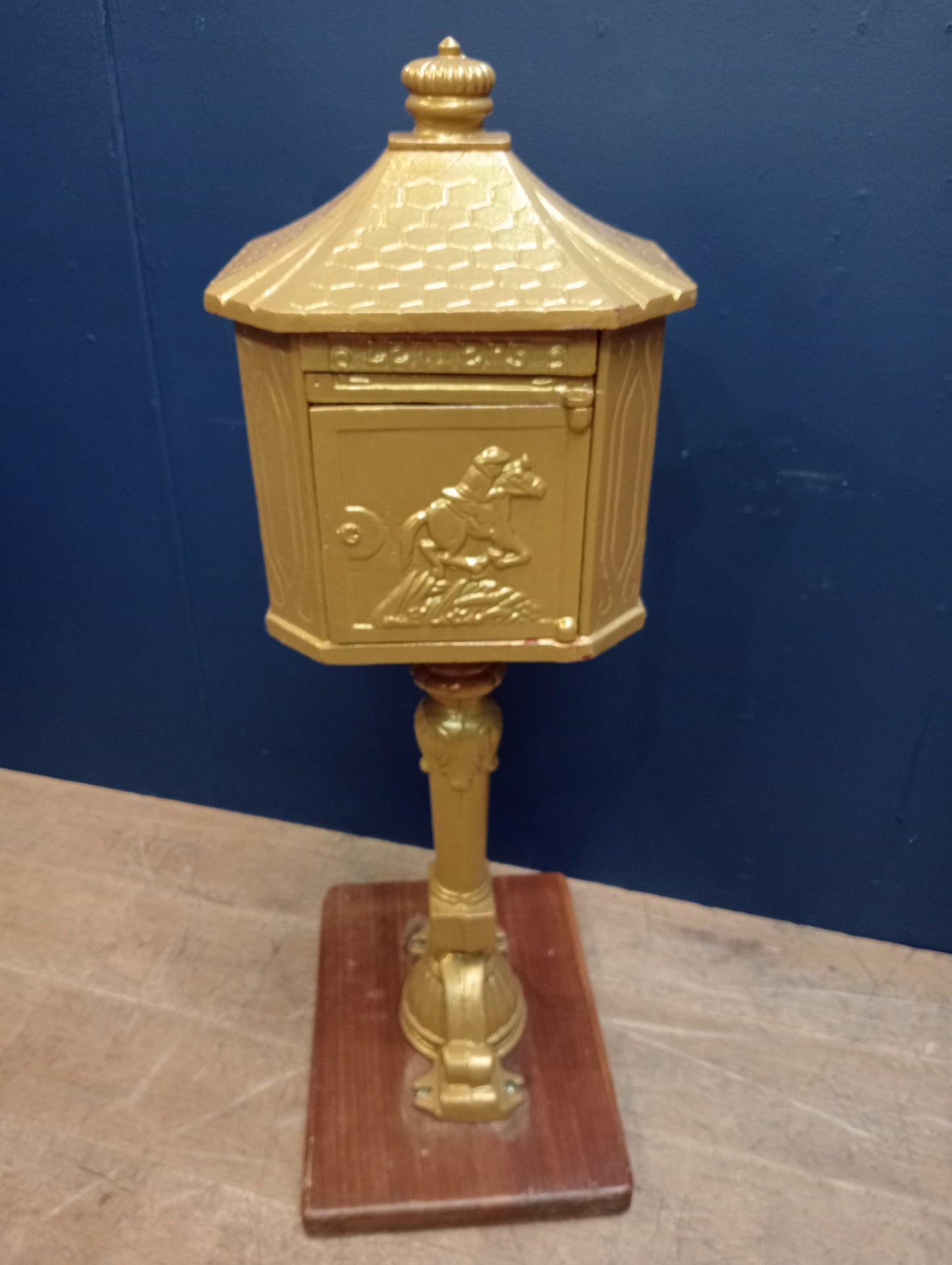 Cast iron postbox on wood base