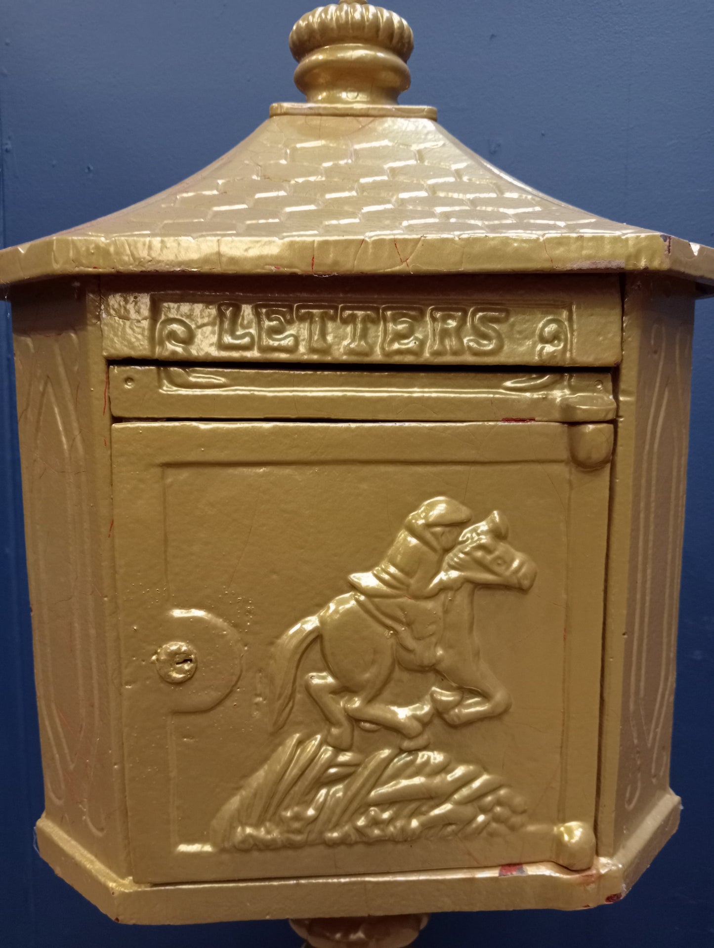 Cast iron postbox on wood base