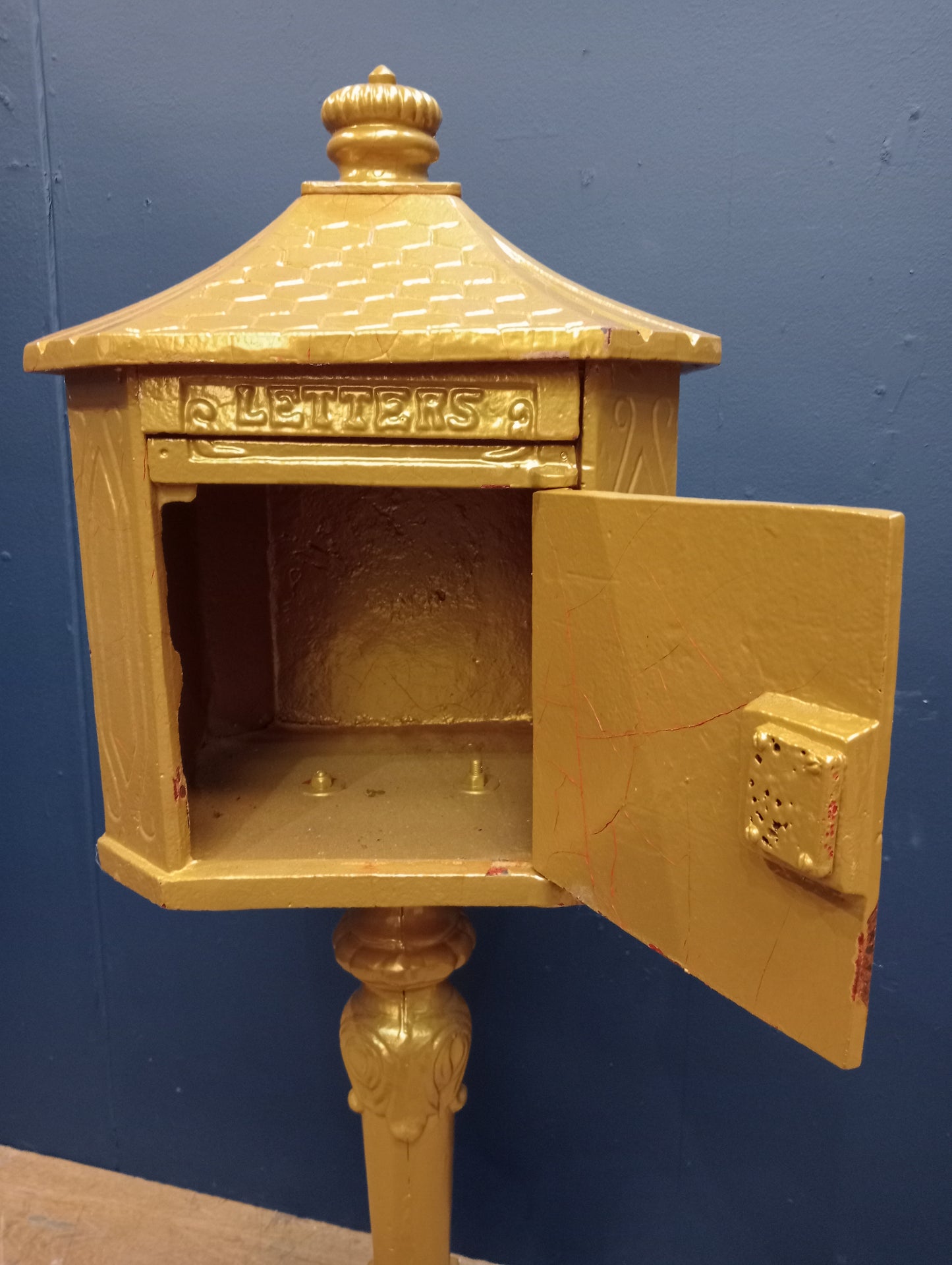 Cast iron postbox on wood base