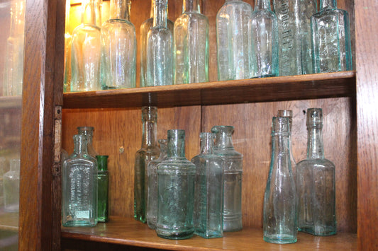 Collection of 20  glass sauce bottles