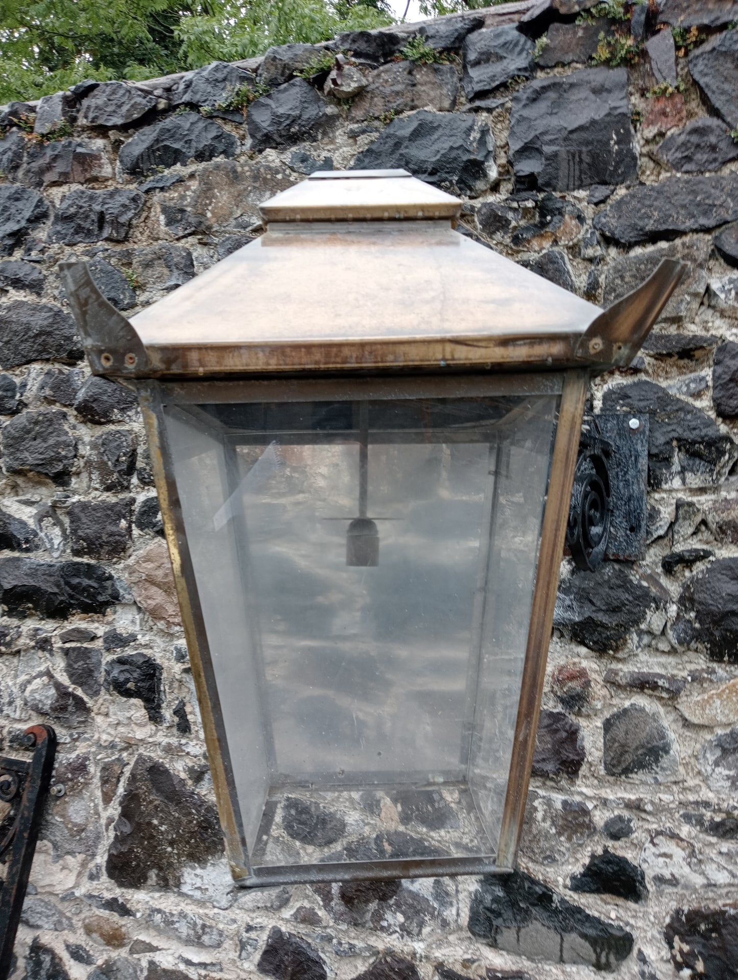 Copper wall light with wrought iron bracket